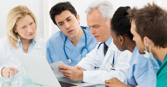 group-of-doctors-nurses-discussing-document_573x300